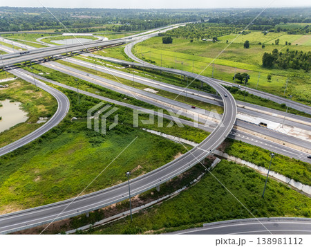 Drone shot a large highway interchange crossing over green farmlands in Thailand Drone shot a large highway interchange crossing over green farmlands in Thailand 138981112