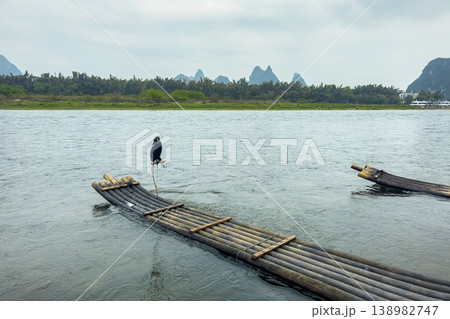 Landscape in Yangshuo Guilin, China Cormorant bird a bamboo raft Landscape in Yangshuo Guilin, China Cormorant bird a bamboo raft 138982747