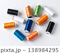 Tailoring supplies. Colorful sewing thread spools on a white background. 138984295