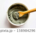 Handwork. Cement in a container with a spatula on a white background. Cement prepared for use in repair and construction. Top view. 138984296