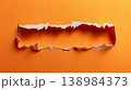 Ripped orange paper background with torn edge texture 138984373