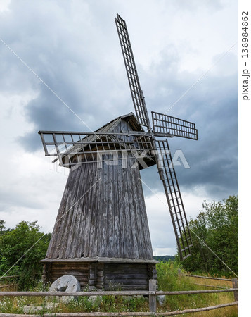Old traditional wooden windmill under a dramatic stormy sky in the countryside. 138984862