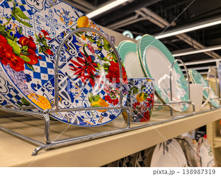 Colorful floral ceramic plates and cups on display rack Colorful floral ceramic plates and cups on display rack 138987319