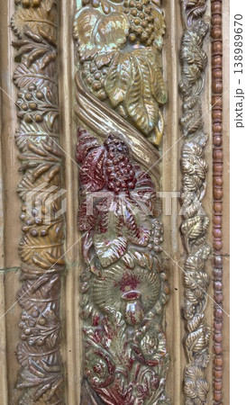Intricate vintage architectural detail with floral and leaf motifs, suitable as textured background Intricate vintage architectural detail with floral and leaf motifs, suitable as textured background 138989670