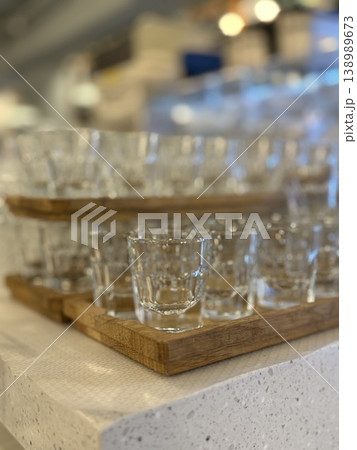 Glasses on wooden trays in a cafe setting with blurred background for drink concept Glasses on wooden trays in a cafe setting with blurred background for drink concept 138989673