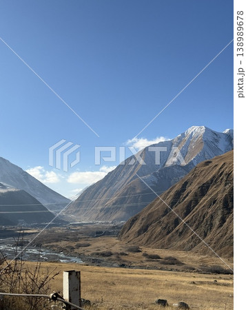 Mountain landscape with snowy peaks and clear blue sky, suitable for background and travel themes Mountain landscape with snowy peaks and clear blue sky, suitable for background and travel themes 138989678