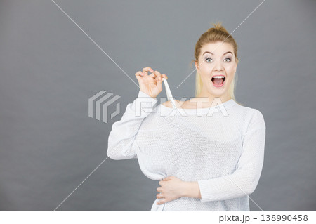 Happy woman holding her bra strap Happy woman holding her bra strap 138990458