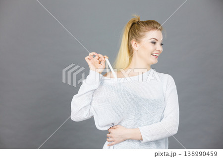 Happy woman holding her bra strap Happy woman holding her bra strap 138990459