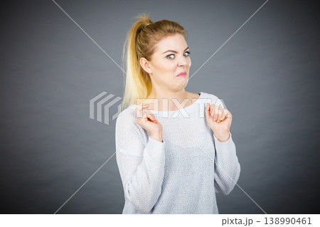 Disgusted woman having funny face expression Disgusted woman having funny face expression 138990461