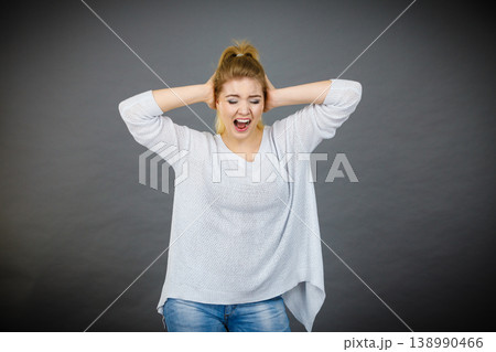 Unhappy woman screaming and yelling in pain Unhappy woman screaming and yelling in pain 138990466
