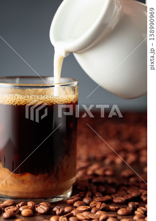 Cream is added to the coffee. Cream is added to the coffee. 138990969