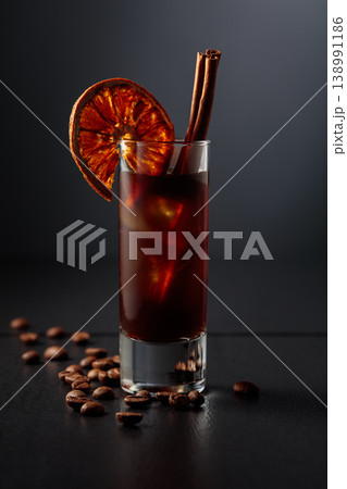 Coffee liquor with ice in tall glass on a black background. 138991186