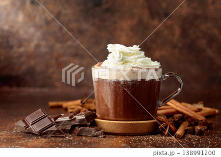Hot chocolate with ingredients on a brown table. 138991200
