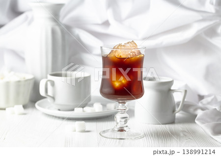 Iced coffee, cup of black coffee and sugar on a white wooden table. 138991214