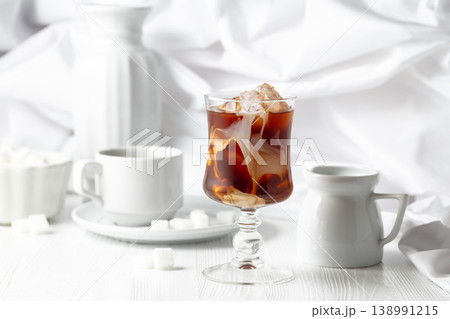 Iced coffee with cream and cup of black coffee. Iced coffee with cream and cup of black coffee. 138991215