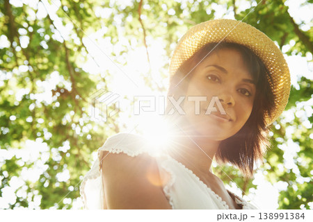 Portrait, trees or woman in park, countryside or natural environment to relax on summer break. Low angle, wellness or person in garden for peace or fresh air on an outdoor holiday vacation in nature Portrait, trees or woman in park, countryside or natural environment to relax on summer break. Low angle, wellness or person in garden for peace or fresh air on an outdoor holiday vacation in nature 138991384