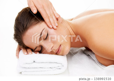 Hand, face and spa massage with a woman in studio isolated on white background to relax. Head, wellness or luxury treatment and a young customer at the salon for physical therapy with a masseuse Hand, face and spa massage with a woman in studio isolated on white background to relax. Head, wellness or luxury treatment and a young customer at the salon for physical therapy with a masseuse 138991510