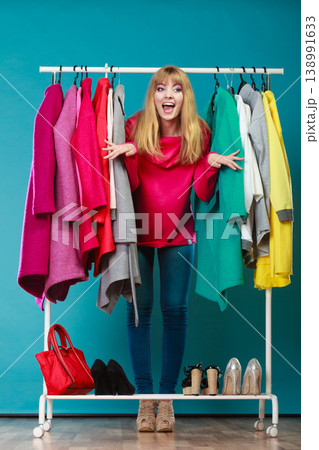 Woman choosing clothes to wear in mall or wardrobe Woman choosing clothes to wear in mall or wardrobe 138991633