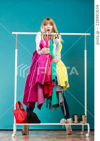 Shocked girl taking all clothes in mall wardrobe Shocked girl taking all clothes in mall wardrobe 138991634