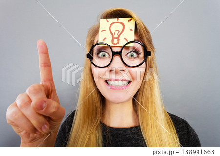 Woman having light bulb mark on forehead thinking Woman having light bulb mark on forehead thinking 138991663