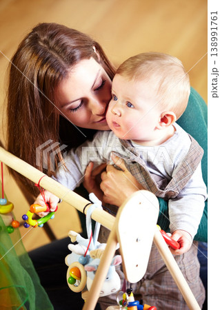 Woman, baby and holding for playing with toys in living room for childhood development in home. Mother, son and bonding for love, trust or together by support in growth, future and hope with care Woman, baby and holding for playing with toys in living room for childhood development in home. Mother, son and bonding for love, trust or together by support in growth, future and hope with care 138991761