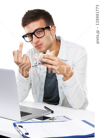 Portrait of man, eating lunch and middle finger in studio isolated on a white background. Business person, sandwich and hand gesture at desk on laptop with rude sign, conflict expression and emoji 138991773