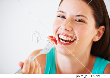 Health, diet and portrait of woman with strawberry eating for nutrition, wellness or snack in studio. Food, happy and face of person with fruit for vitamins, detox and lose weight on white background 138991932