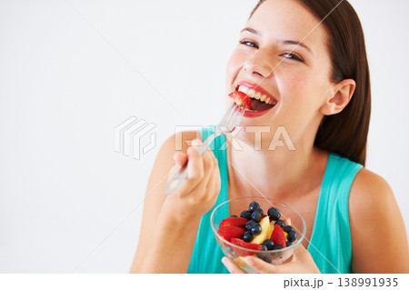 Fruit salad, happy and portrait of woman in studio eating for nutrition, wellness and snack. Food, balance diet and face of person with berries for vitamins, detox and lose weight on white background 138991935