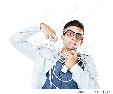 Portrait of man in glasses tangled in wire, cables and isolated on a white background. Face of serious geek wrapped in cord and tech of nerd or electrician, mistake and problem, chaos or struggle 138991947