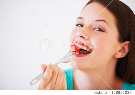 Health, happy and portrait of woman with strawberry eating for nutrition, wellness and snack in studio. Food, balance diet and face of person for vitamins, detox and lose weight on white background 138992086