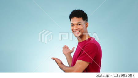 Portrait, happy man and smile with presentation in studio for promotion mockup on blue background. New York, male model and hand for show of announcement, offer and discount in space with gesture Portrait, happy man and smile with presentation in studio for promotion mockup on blue background. New York, male model and hand for show of announcement, offer and discount in space with gesture 138992097