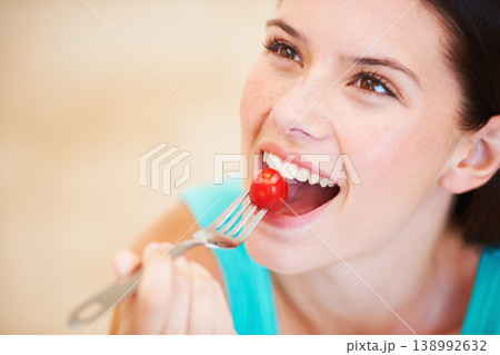 Health, diet and face of woman with tomato eating for nutrition, wellness and snack for hunger. Food, happy and smile of person with vegetable salad for vitamins benefits, detox and lose weight 138992632