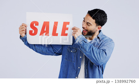 Man, sale and excited with board in studio mockup, shopping discount and advertising retail announcement. Young person, arab and marketing for deal promotion with product launch by white background Man, sale and excited with board in studio mockup, shopping discount and advertising retail announcement. Young person, arab and marketing for deal promotion with product launch by white background 138992760