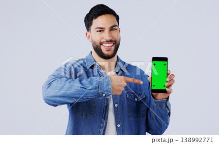 Man, smartphone or pointing to green screen in portrait, mockup space or happy for advertising. Arab person, smile or face in marketing of tracking markers, mobile app or contact by white background Man, smartphone or pointing to green screen in portrait, mockup space or happy for advertising. Arab person, smile or face in marketing of tracking markers, mobile app or contact by white background 138992771