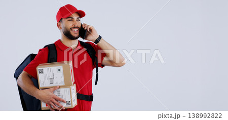 Delivery man, phone call and box in studio, space and mockup in talk for location, info or supply chain by background. Courier, smartphone and backpack with cardboard package, product and promotion Delivery man, phone call and box in studio, space and mockup in talk for location, info or supply chain by background. Courier, smartphone and backpack with cardboard package, product and promotion 138992822
