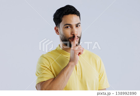 Secret, man and portrait in studio for sign of privacy, surprise sales and confidential deal on white background. Indian model with finger on lips for quiet, gossip news and mystery emoji to whisper Secret, man and portrait in studio for sign of privacy, surprise sales and confidential deal on white background. Indian model with finger on lips for quiet, gossip news and mystery emoji to whisper 138992890