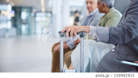 Hand, suitcase and a business person in the airport for travel, waiting to board his international flight. Corporate, luggage and a professional employee in a terminal or lobby for a global trip 138992915