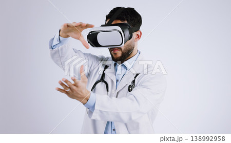 Man, doctor and VR or futuristic glasses with healthcare software, metaverse vision and user experience in studio. Medical worker with 3d exam and hands for virtual reality tech on a white background Man, doctor and VR or futuristic glasses with healthcare software, metaverse vision and user experience in studio. Medical worker with 3d exam and hands for virtual reality tech on a white background 138992958