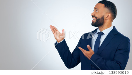 Offer, pointing and corporate businessman in studio with smile, deal announcement and mockup space. News, advice and happy man with choice, presentation or business opportunity on white background. 138993019