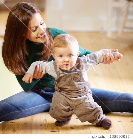 Mother, baby and smile for help with standing for development, motor skills or walking with assistance. Boy, infant or toddler with excited expression on face for future growth, milestone and support Mother, baby and smile for help with standing for development, motor skills or walking with assistance. Boy, infant or toddler with excited expression on face for future growth, milestone and support 138993055