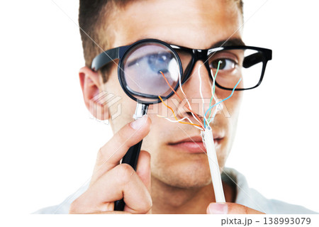 Electrician, cables and portrait of man with test, analysis and check with magnifying glass in white background. Studio, technician or working with electricity, wires or search for solution and power 138993079