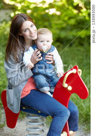 Portrait, mother and baby with toy, horse and park for fun in bond by playing for outside together. Happy woman, infant or smile for milestone, future growth or development with love, support or care Portrait, mother and baby with toy, horse and park for fun in bond by playing for outside together. Happy woman, infant or smile for milestone, future growth or development with love, support or care 138993080