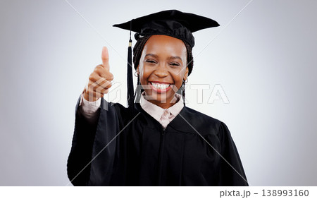 Graduation cap, thumbs up and woman or student success with celebration, education and learning or college achievement in studio. Portrait of an african graduate with like emoji on a white background Graduation cap, thumbs up and woman or student success with celebration, education and learning or college achievement in studio. Portrait of an african graduate with like emoji on a white background 138993160
