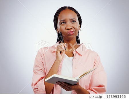 Woman, notebook and thinking, planning or learning and studying with solution or goals on a white background. African student for problem solving with notes and why face, confused or ideas in studio 138993166