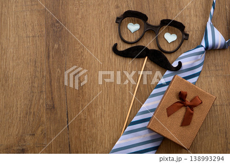 Father's day celebration with tie, gift, and mustache glasses Father's day celebration with tie, gift, and mustache glasses 138993294