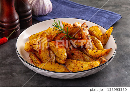 Baked crispy hot potato with rosemary Baked crispy hot potato with rosemary 138993580