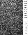 Grey fluffy carpet. Fur background, monochrome. Textured black and white surface. Vertical abstract background. Doormat backdrop. 138993811