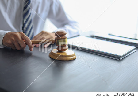 Lawyer Reviewing Contract and Documents with Gavel on Desk. Lawyer Reviewing Contract and Documents with Gavel on Desk. 138994062