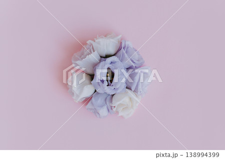 Beautiful white and purple Eustoma (Lisianthus) flowers on a pink pastel background. Beautiful white and purple Eustoma (Lisianthus) flowers on a pink pastel background. 138994399