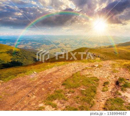 sunset over summer landscape. mountain path through the grassy slope turns uphill to the sky with rainbow. scenic view. hiking trail path through borzhava ridge. travel ukraine mountains concept 138994687
